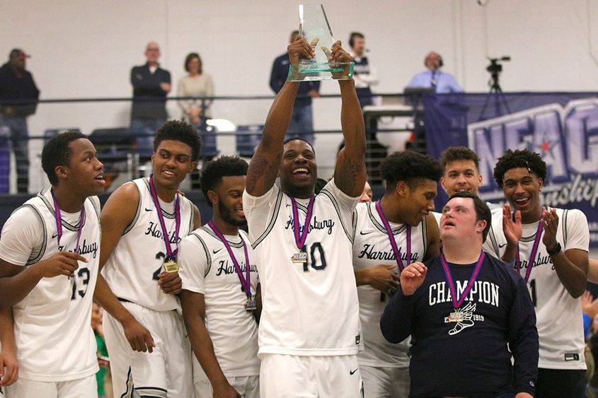 basketball players holding trophy