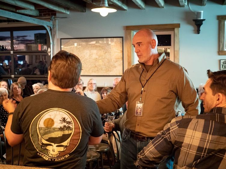 Journalist Tim Lambert talking with community members