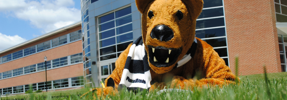 Nittany Lion mascot and olmsted building